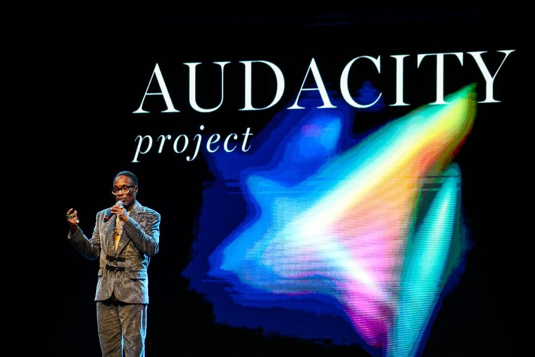 Billy Porter on stage at the Audacity Project launch with the AUDACITY project logo projected behind him