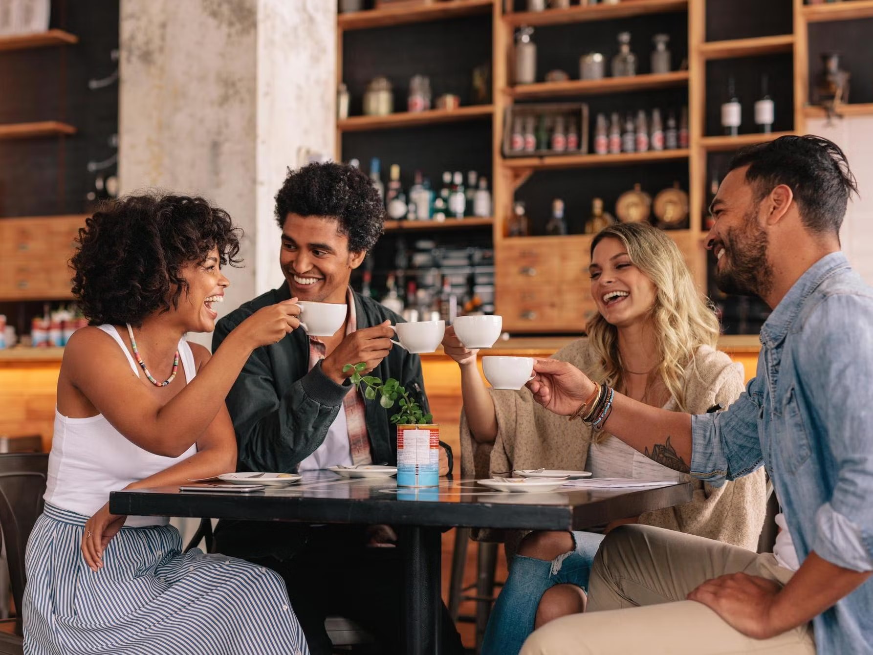 Friends laughing and enjoying coffee together