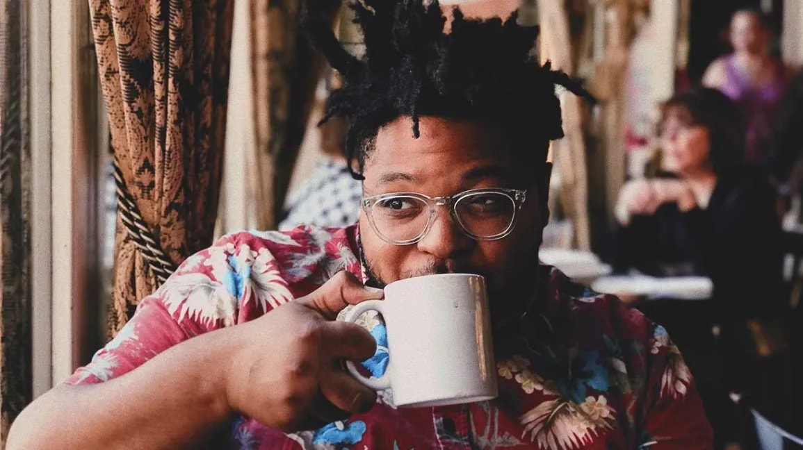 Man enjoying a cup of coffee at a Pittsburgh café