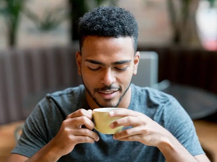 Man savoring a cup of coffee