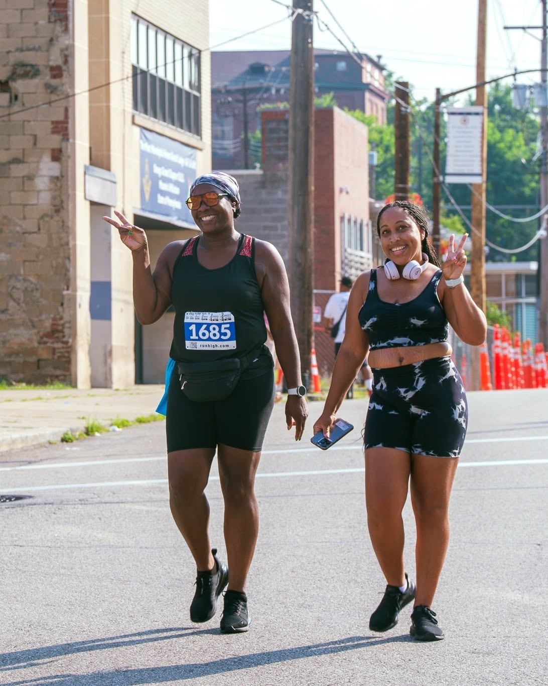 Participants smiling during the Historic Hill 5K Run, Walk & Ride in Pittsburgh's Hill District