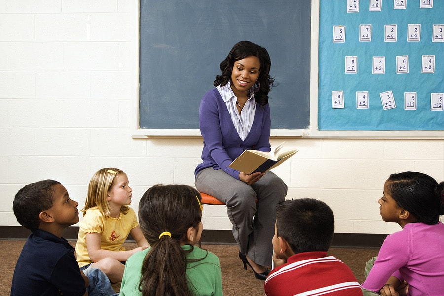 Teacher reading to elementary school students in a classroom