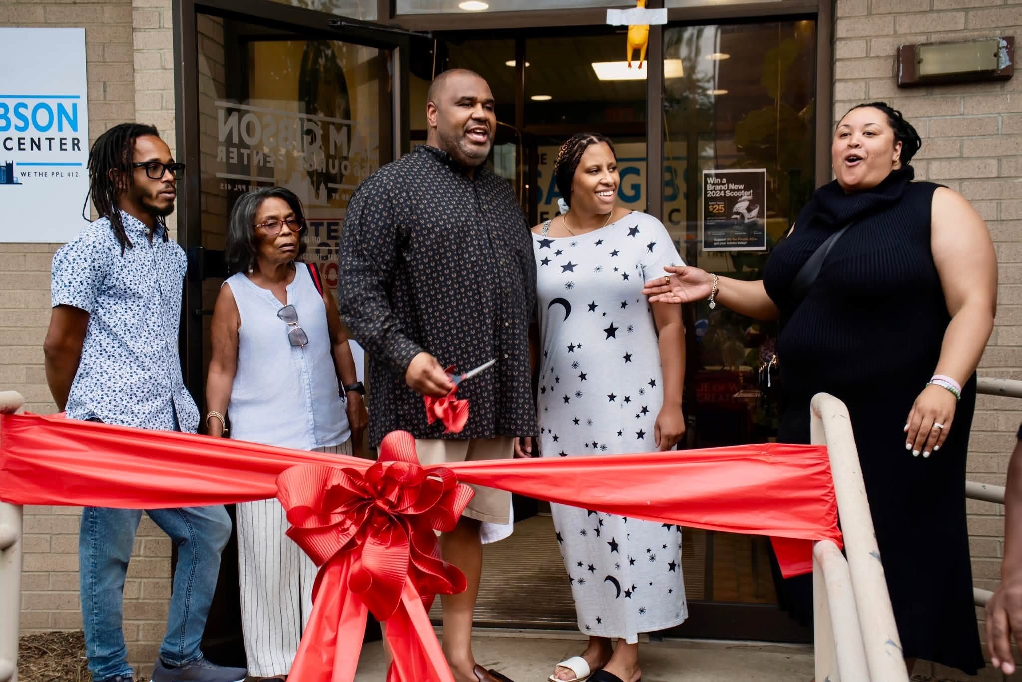 Sam Gibson and community members at the grand opening of the We The Ppl 412 Resource Center