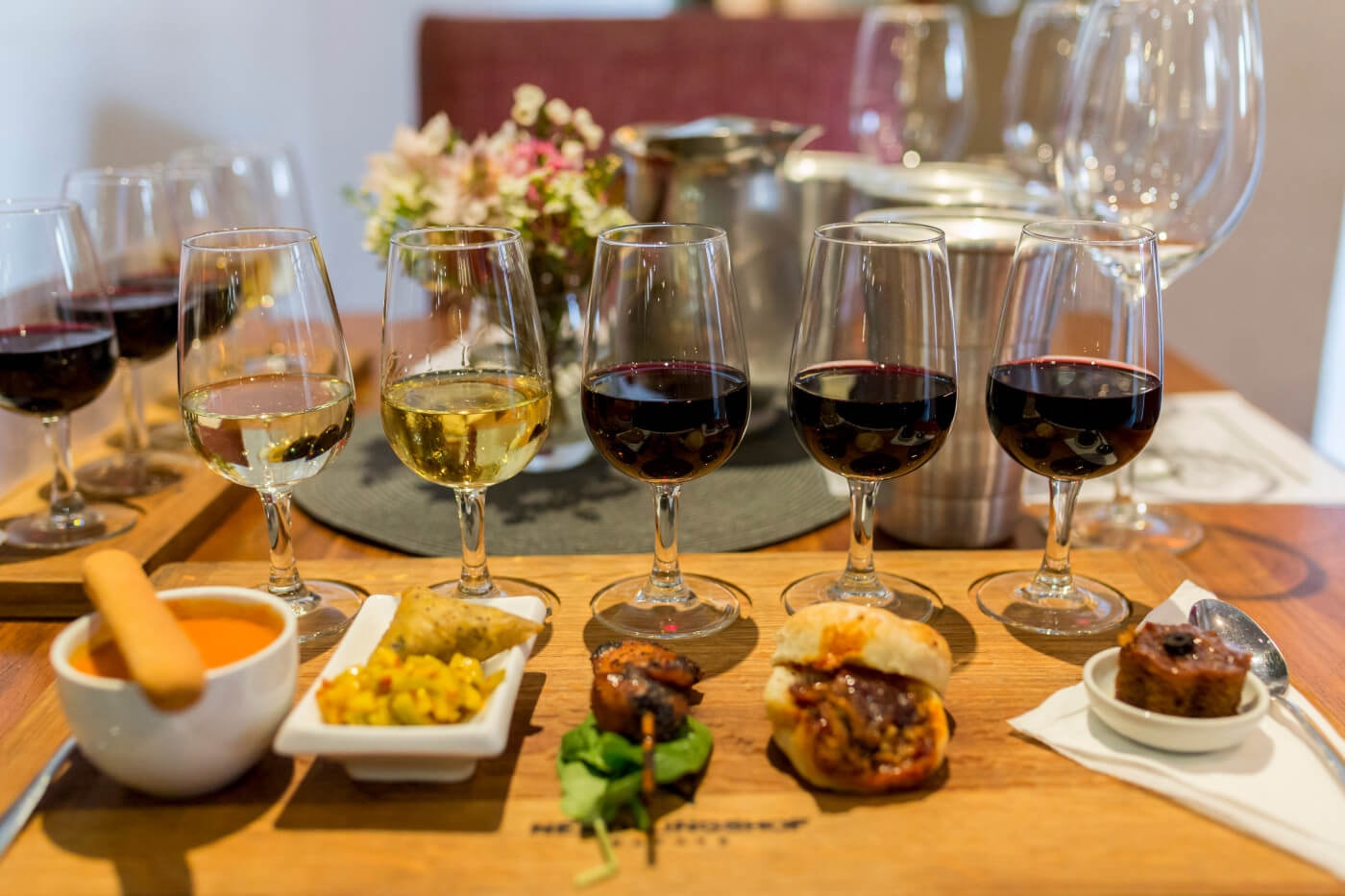Wine and food tasting spread with multiple glasses of red and white wine