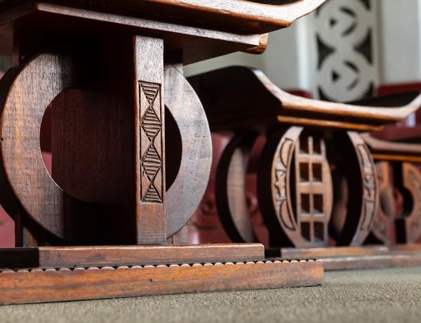 Carved wooden stools on the floor of the African Heritage Classroom
